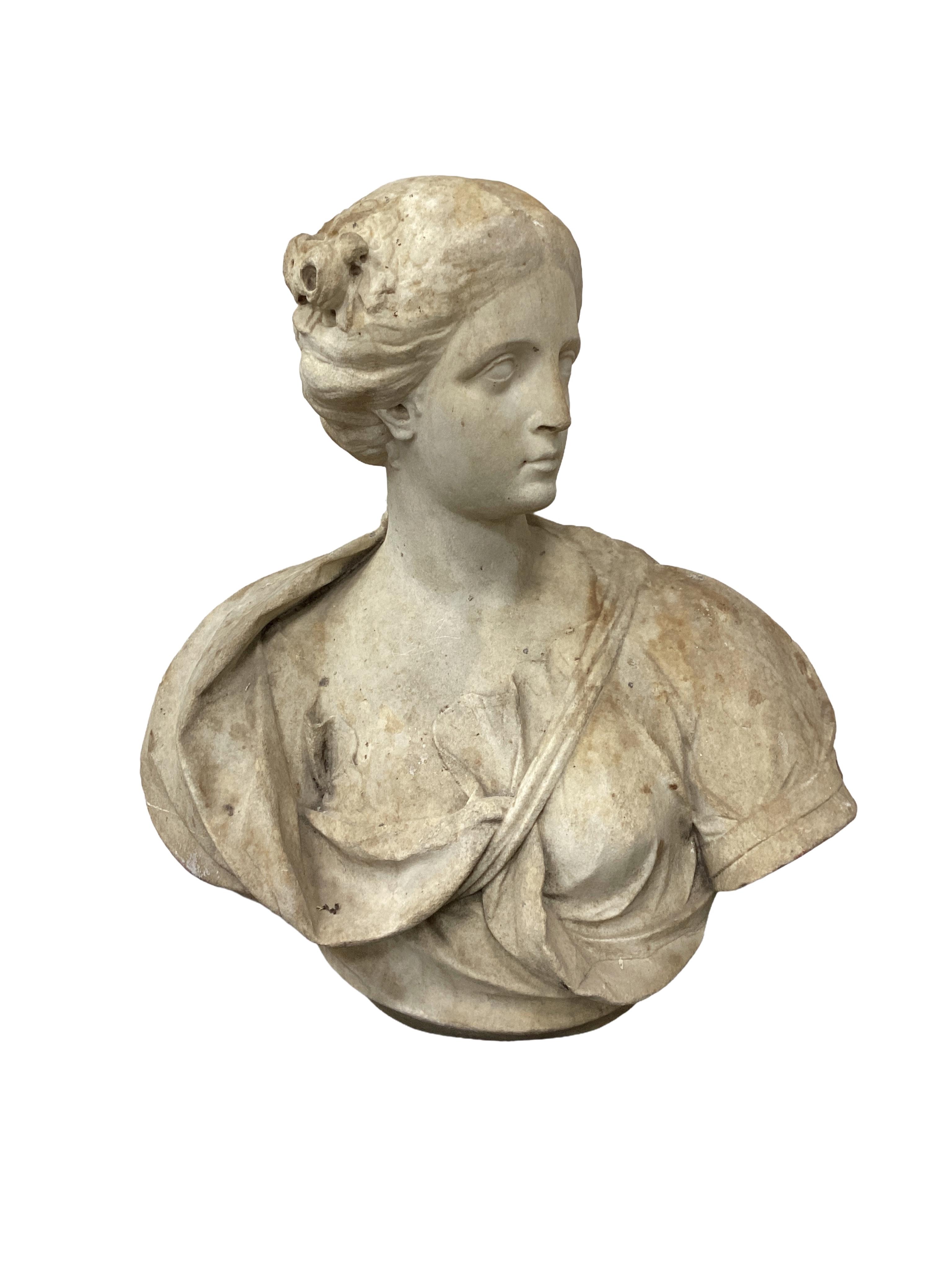 An oversized white marble bust of a classical maiden, 19th century